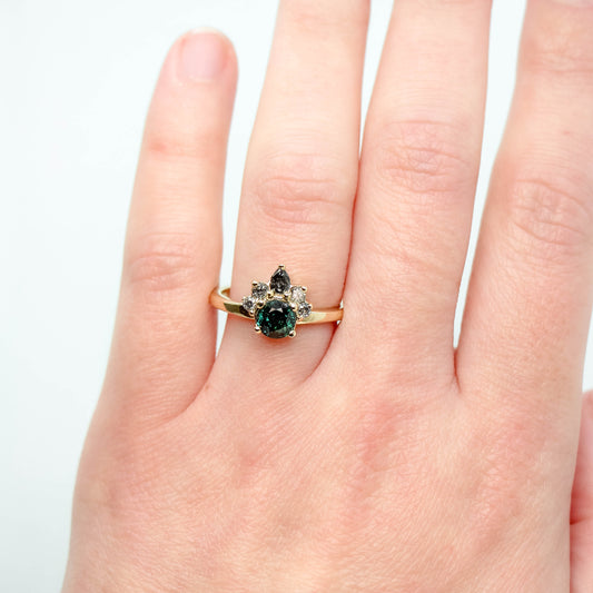 Blair Ring with a 1.09 Carat Round Teal Green Sapphire and Gray and Black Accent Diamonds in 10k Yellow Gold - Ready to Size and Ship - Midwinter Co. Alternative Bridal Rings and Modern Fine Jewelry