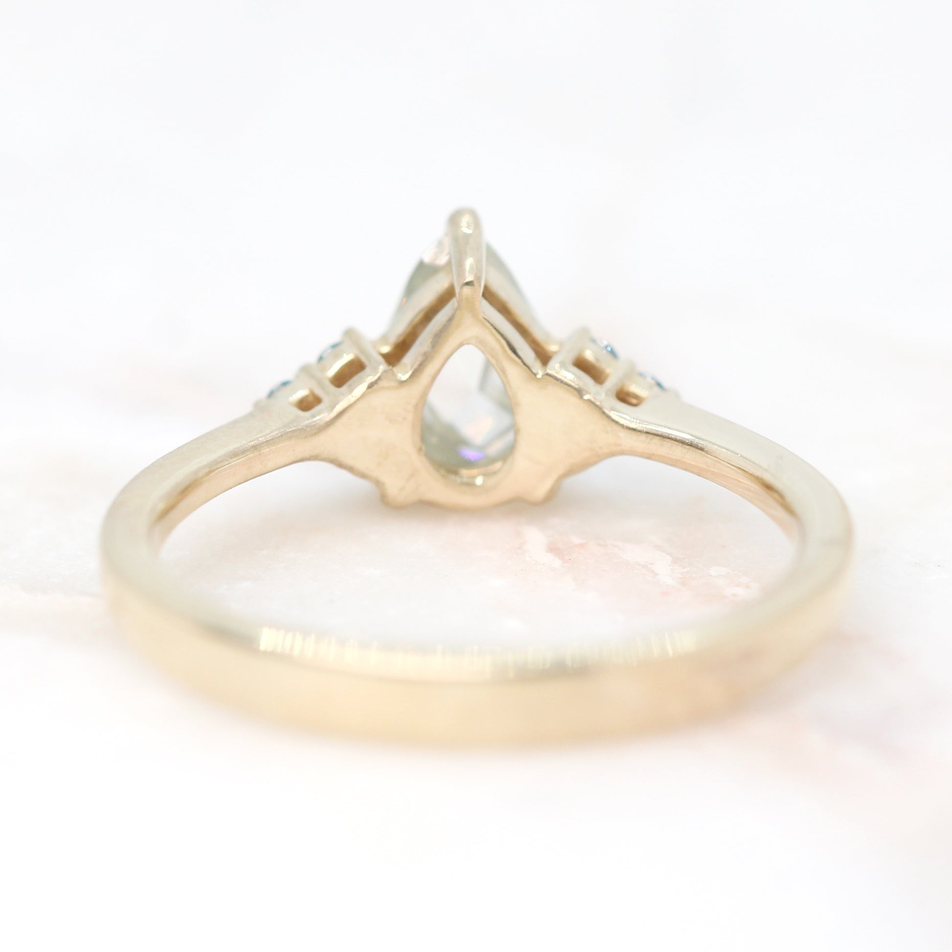 Imogene Ring with a 0.74 Carat Clear Pear Moissanite and Blue Diamond Accents in 14k Yellow Gold - Ready to Size and Ship - Midwinter Co. Alternative Bridal Rings and Modern Fine Jewelry