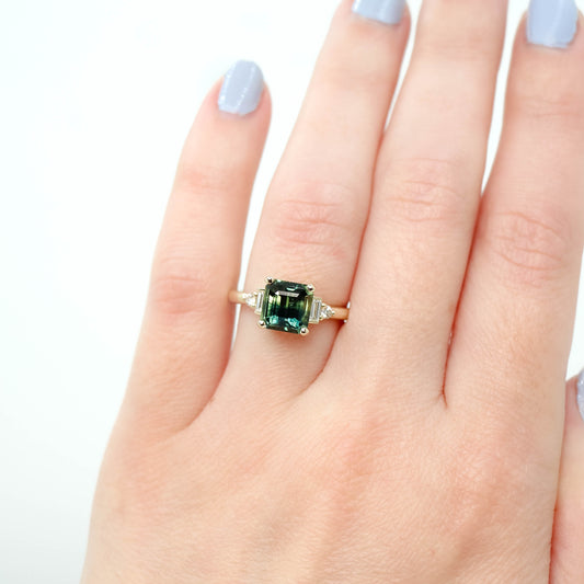 Iris Ring with a 2.75 Carat Asscher Cut Teal Sapphire and White Accent Diamonds in 14k Yellow Gold - Ready to Size and Ship - Midwinter Co. Alternative Bridal Rings and Modern Fine Jewelry