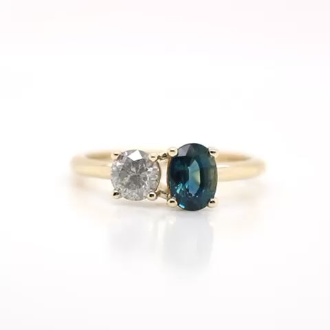 Toi et Moi Ring with a 0.58 Light Gray Round Salt and Pepper Diamond and a 1.11 Carat Teal Blue Oval Sapphire in 14k Yellow Gold - Ready to Size and Ship