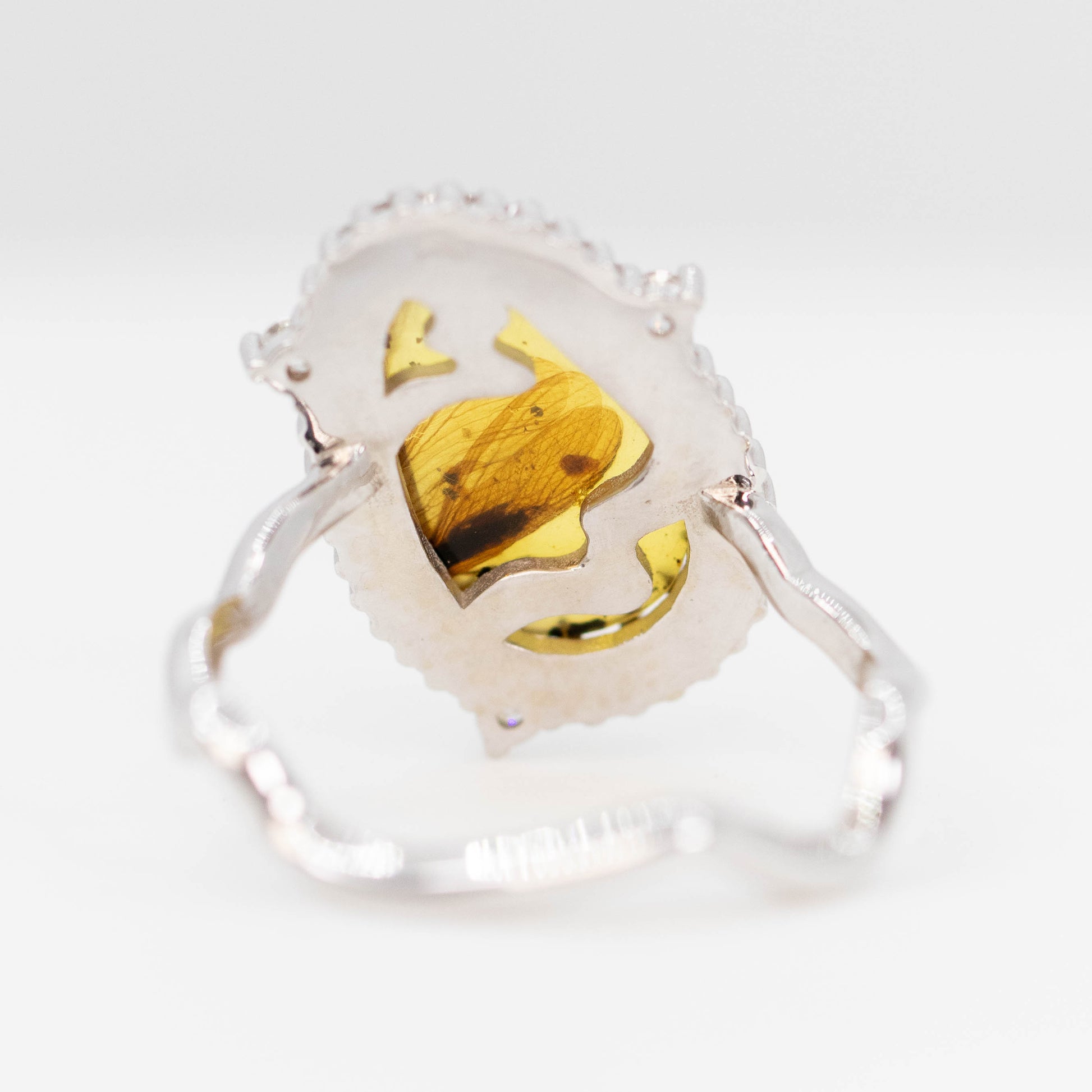Beatrix Ring with a 1.33 Carat Pear Cabochon Amber with Internal Insect Wings and White Accent Diamonds in 14k White Gold - Ready to Size and Ship - Midwinter Co. Alternative Bridal Rings and Modern Fine Jewelry