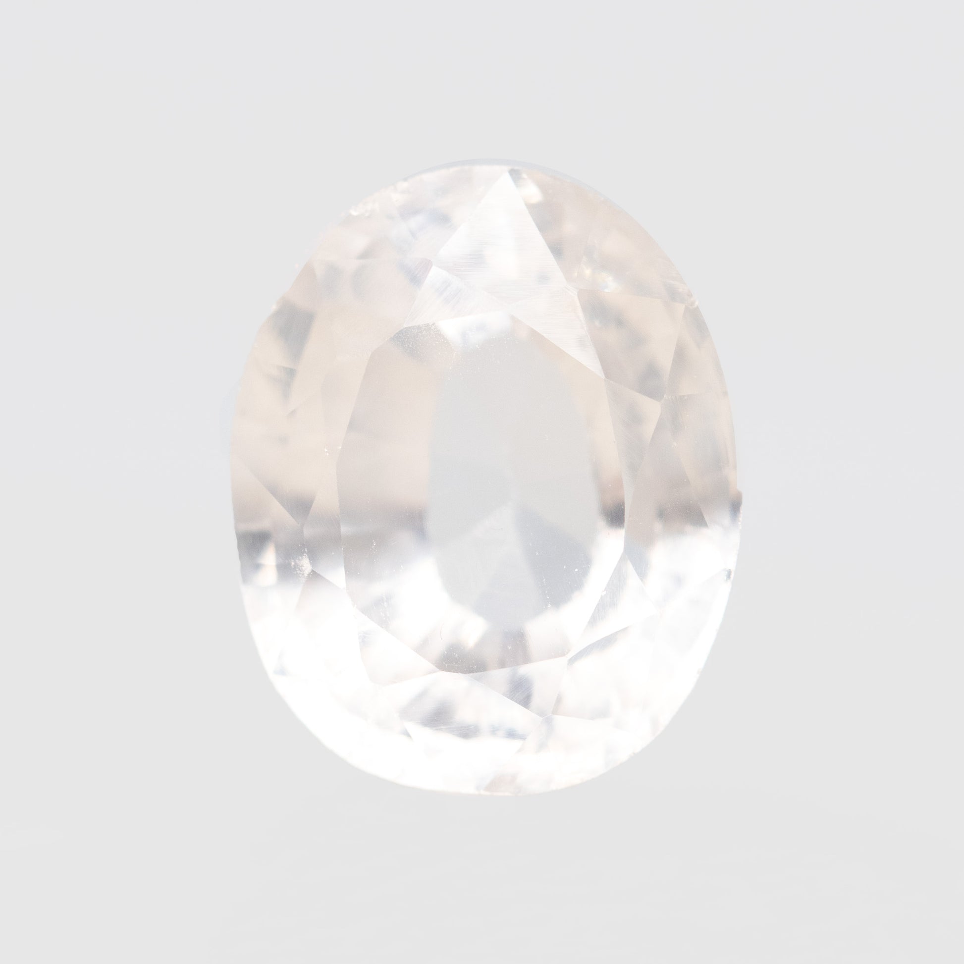 CAELEN (J)  7.28 Carat Clear Oval Lab Grown Sapphire for Custom Work - Inventory Code COS728 - Midwinter Co. Alternative Bridal Rings and Modern Fine Jewelry