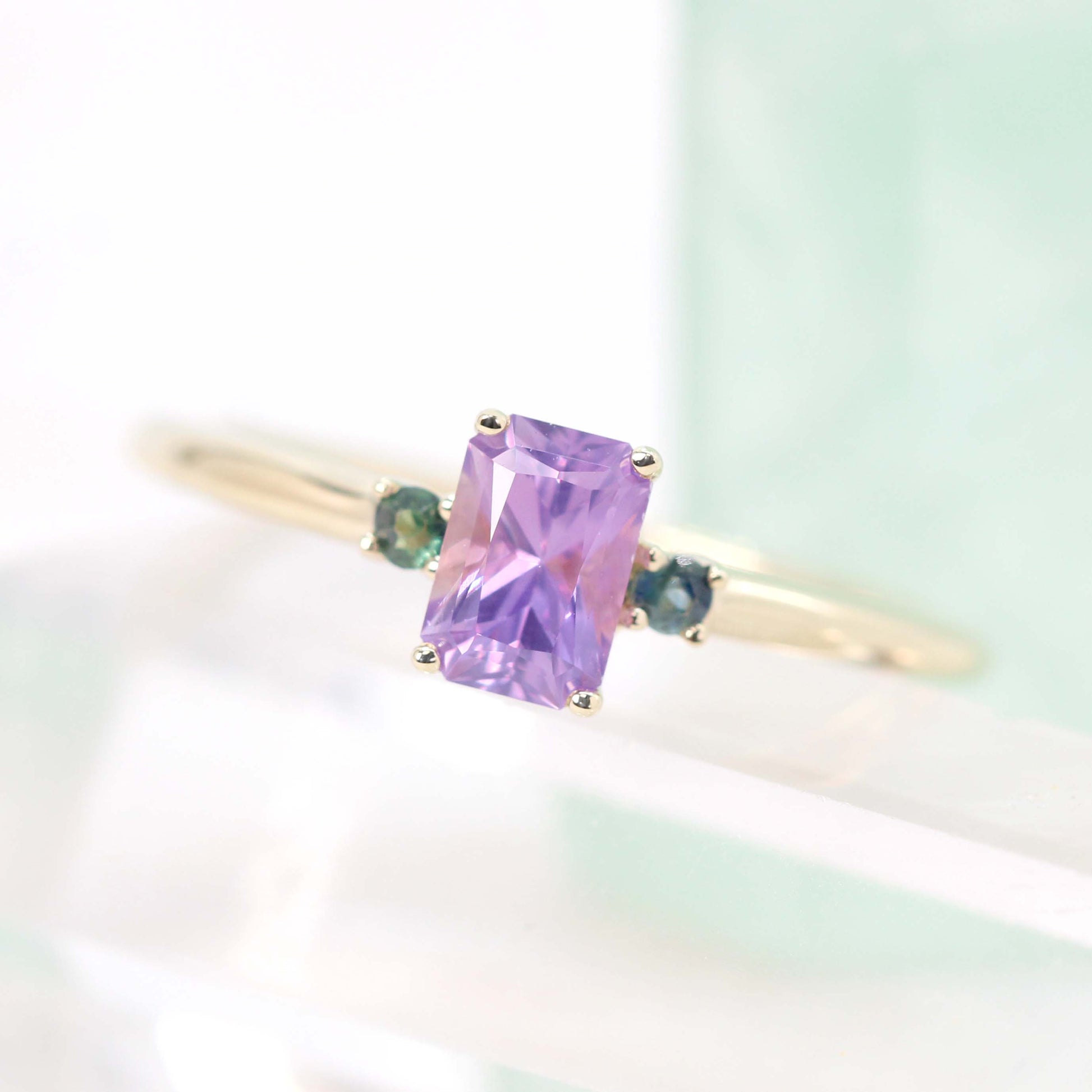 Terra Ring with a 0.81 Carat Radiant Cut Purple Sapphire and Teal Sapphire Accents in 14k Yellow Gold - Ready to Size and Ship - Midwinter Co. Alternative Bridal Rings and Modern Fine Jewelry