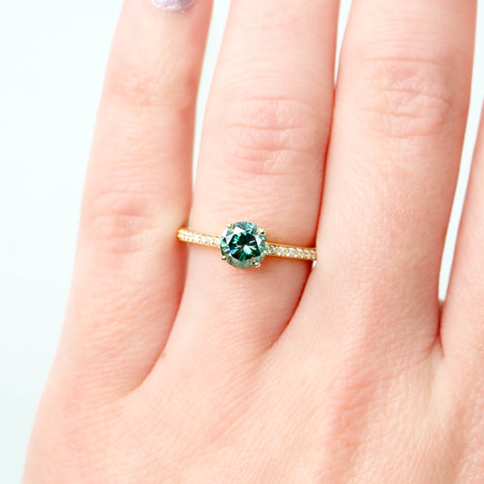 Imani Ring with a 0.80 Carat Round Black and Teal Moissanite and White Accent Diamonds in 14k Yellow Gold - Ready to Size and Ship