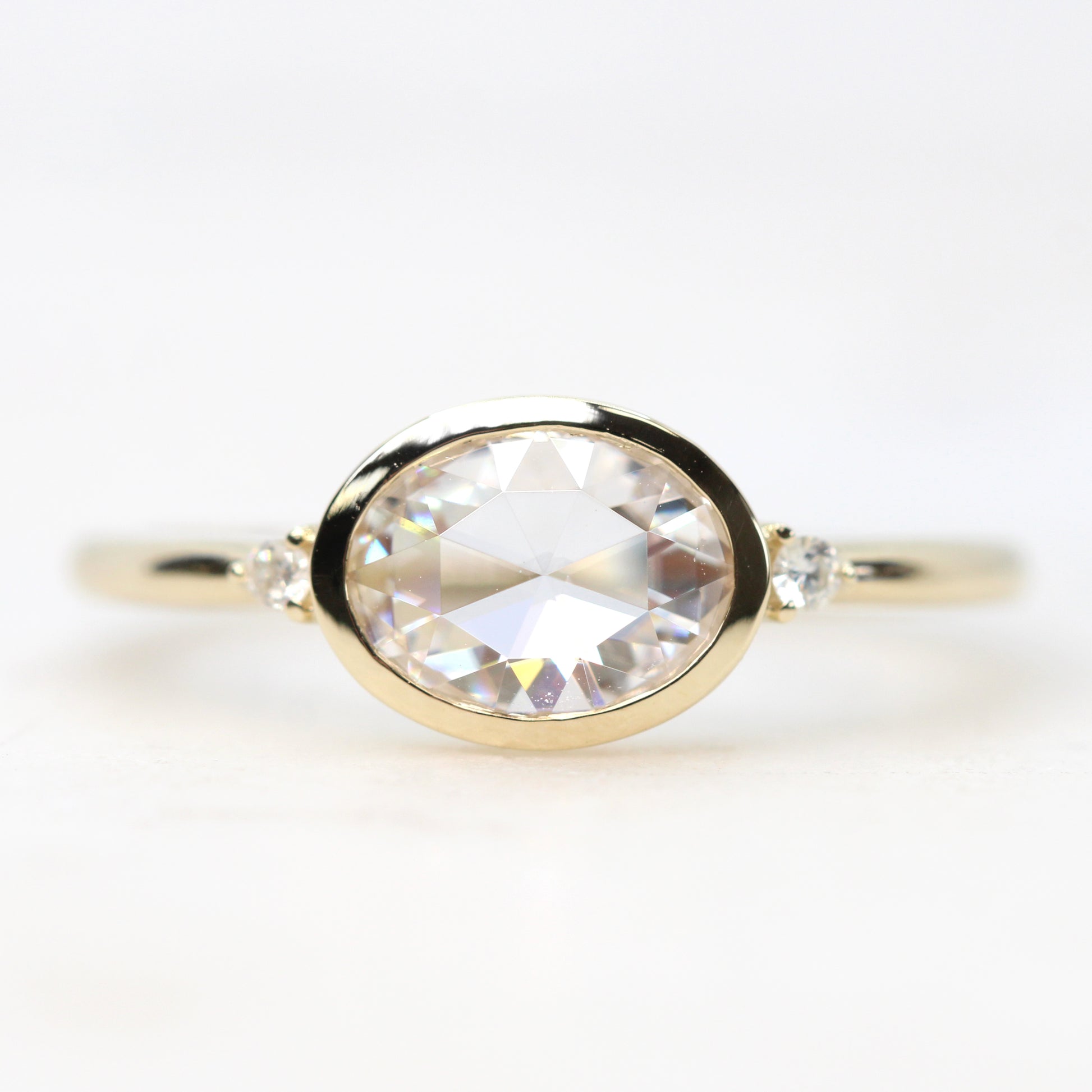 Beatrice Ring with a 0.66 Carat Clear Oval Moissanite and Round Accent Moissanites - Made to Order, Your Choice of Gold - Midwinter Co. Alternative Bridal Rings and Modern Fine Jewelry