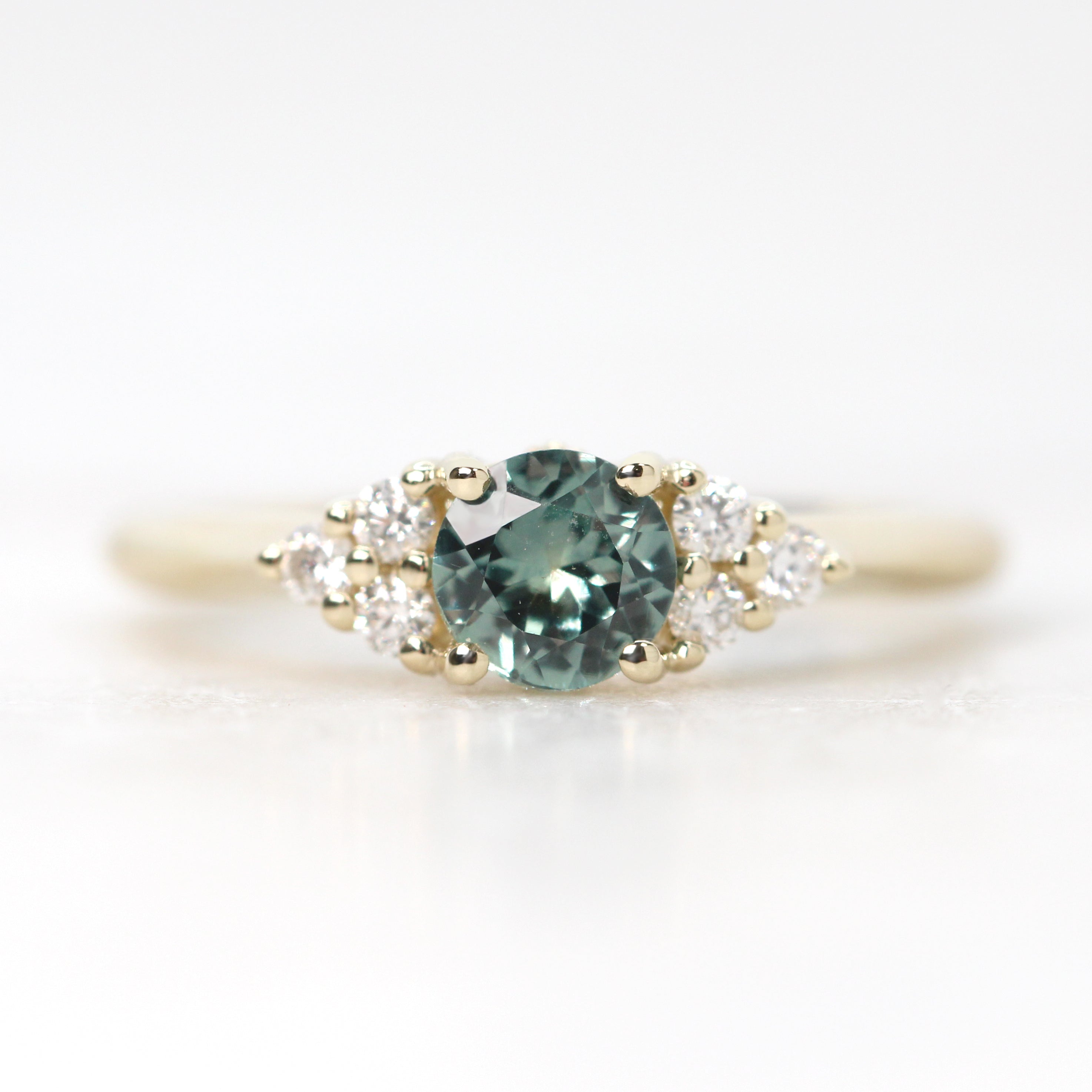 Aster Ring with a 0.57 Carat Light Teal Round Montana Sapphire and White Accent Diamonds in 14k Yellow Gold - Ready to Size and Ship - Midwinter Co. Alternative Bridal Rings and Modern Fine Jewelry