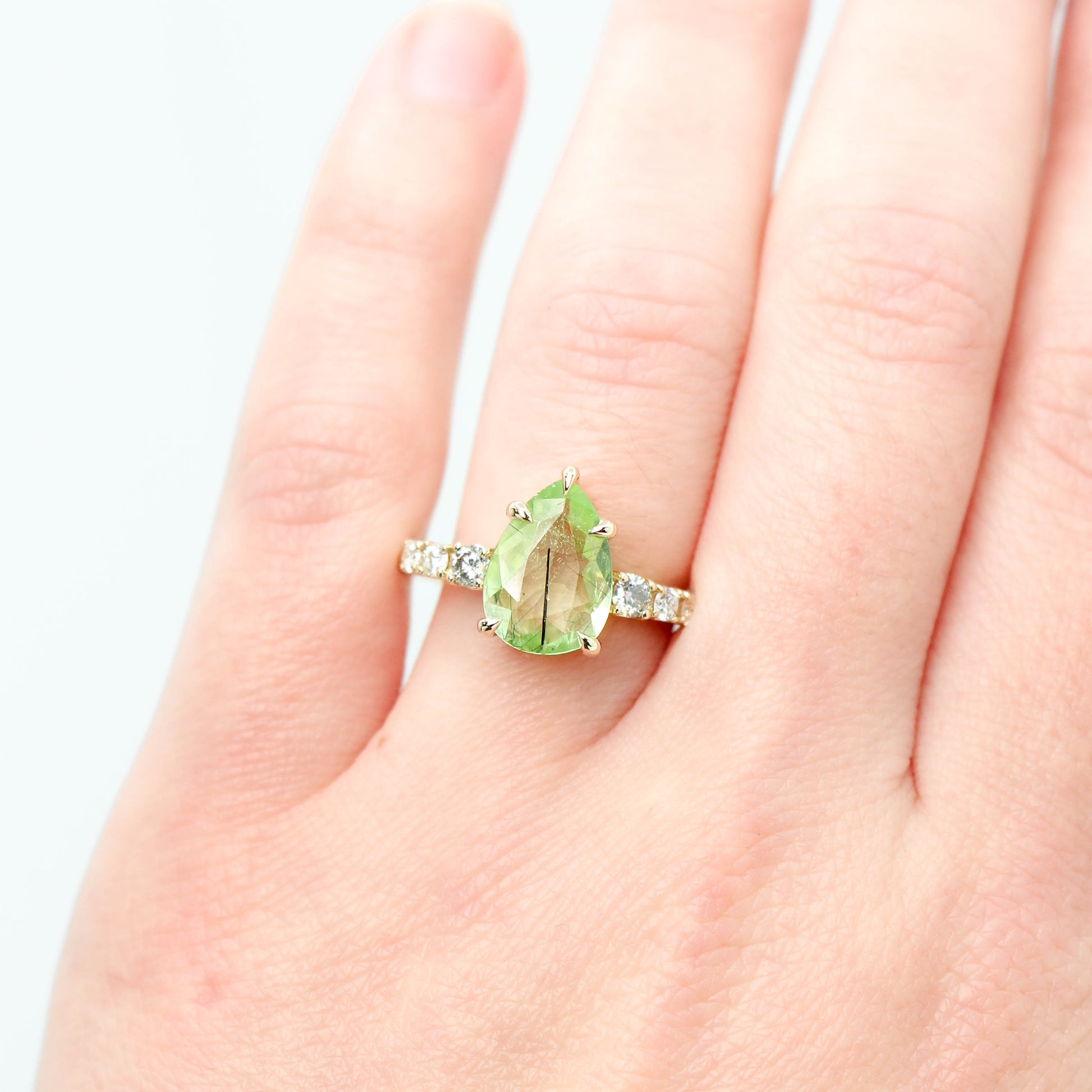 Tina Ring with a 2.58 Carat Light Green Pear Peridot and Gray and White Accent Diamonds in 14k Yellow Gold - Ready to Size and Ship - Midwinter Co. Alternative Bridal Rings and Modern Fine Jewelry