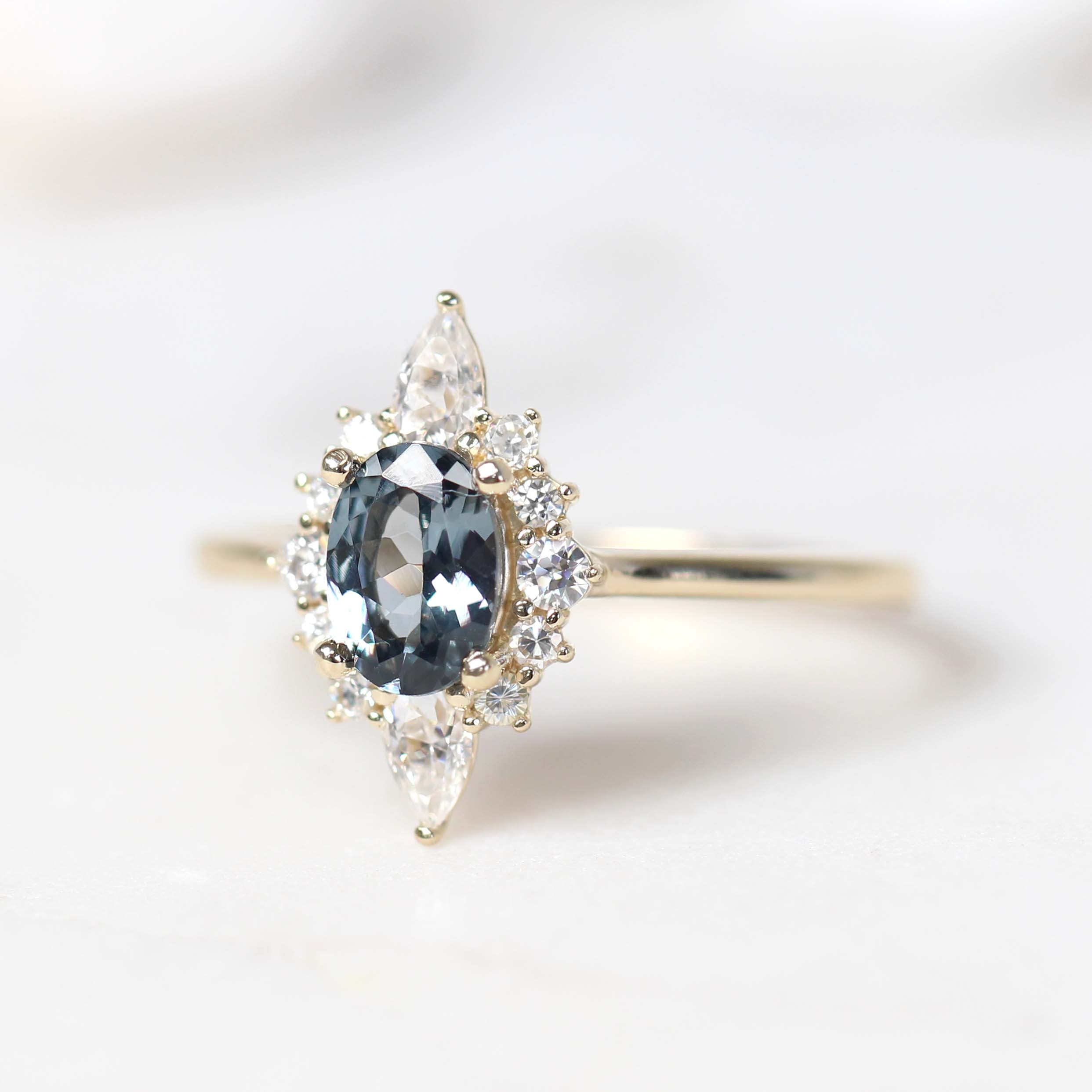 Noelle Ring with a 0.88 Carat Blue Gray Oval Spinel and White Accent Moissanites in 14k Yellow Gold - Ready to Size and Ship - Midwinter Co. Alternative Bridal Rings and Modern Fine Jewelry